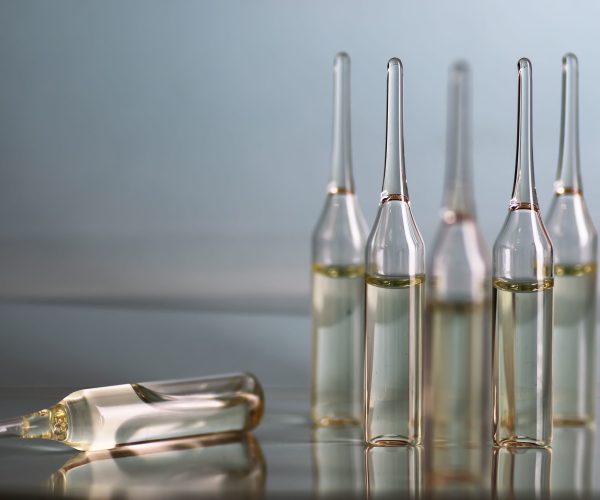 transparent vials of medicine